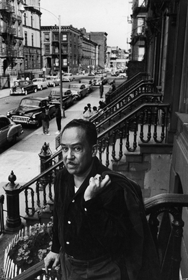 Langston Hughes    June 1958  on the steps in front of his house in Harlem.